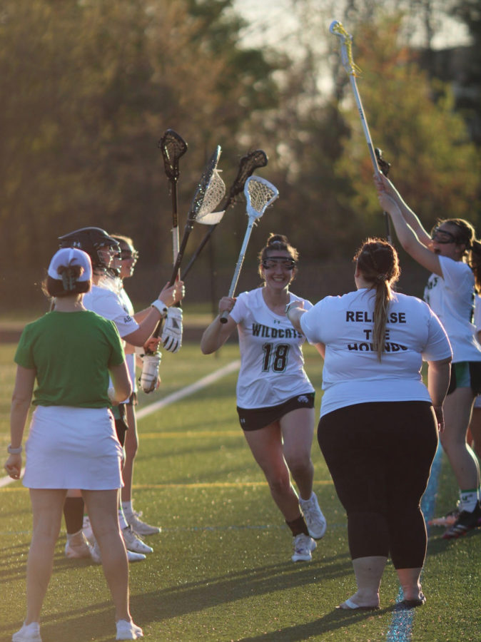 Senior captain and midfielder Olivia McCloskey runs through her teammates before the Whitman game. McCloskey committed to Saint Josephs University to continue her career after high school.