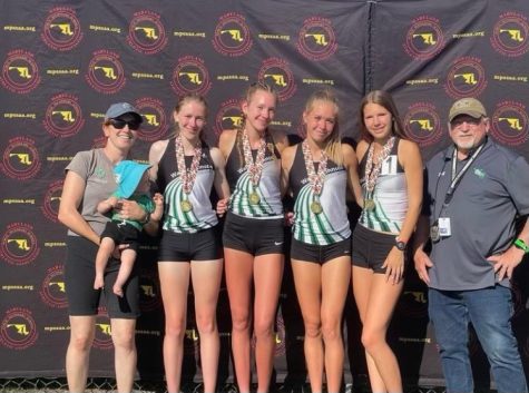 The girls 4x800m state champions pose with their coaches. (From left: Coach Ashley St. Denis, junior Carolyn Hultman, sophomore Megan Raue, junior Mackenzie Raue, junior Zuzana Huserova, Coach Thomas Martin). The girls distance have been dominant all season and are looking to break the school outdoor 4x800m record at Nike Nationals on June 16.