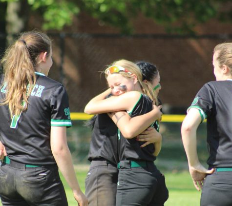 Freshman Elizabeth Borissow hugs senior Maya Rickles while others cry following the teams 18-0 loss to Urbana. Despite losing four seniors this year, talents like Borissow and other freshmen will return next year to compete again.