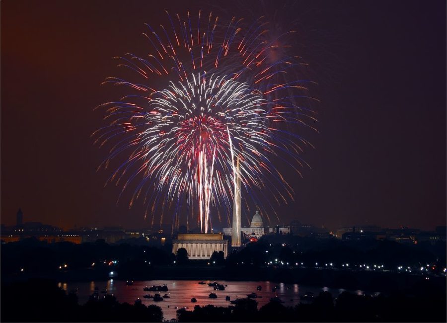 Fourth+of+July+fireworks+illuminate+the+Washington+Monument+and+Lincoln+Memorial.