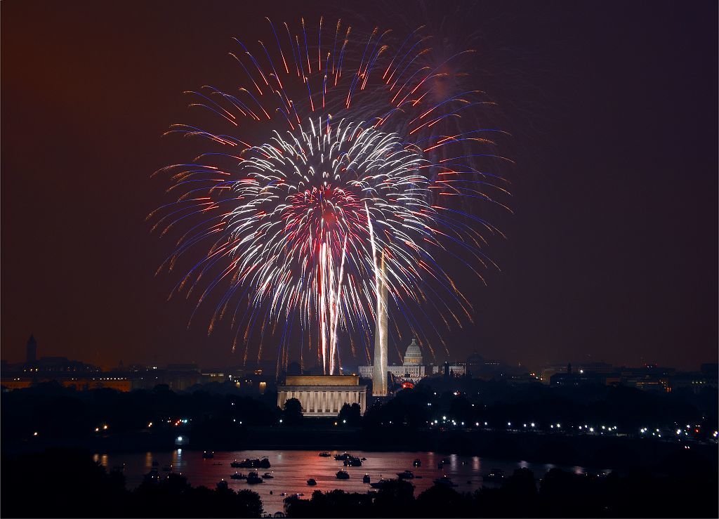 Fourth of July fireworks illuminate the Washington Monument and Lincoln Memorial.