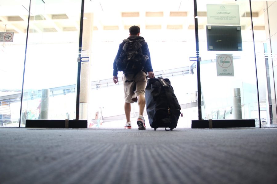 A+student+walks+through+the+airport+doors+ready+to+board+his+flight.+Many+students+around+the+world+choose+to+take+a+year+off+before+college+to+travel+for+other+learning+opportunities+and+experiences.