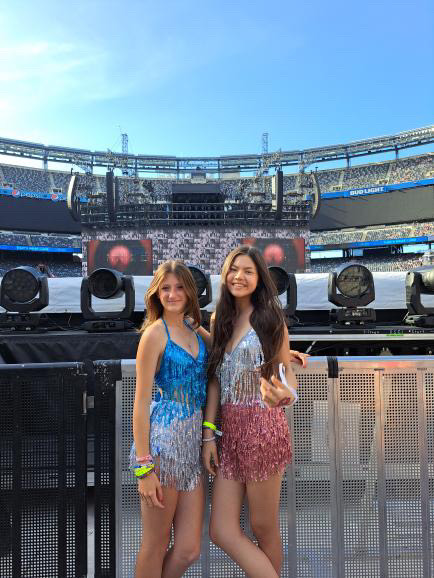 Sophomore friends Elsa Santighian and Lena Sbaschnig pose in the front row of their General Admission seats, ready for Taylor Swift to appear on stage.  Santighian (left) dresses as Swift’s “1989” era, while Sbaschnig (right) dresses as Swift’s “Lover” era.  “Taylor walked straight up to us and looked at us during ‘my tears ricochet’ and ‘The Archer,’” Santighian said.