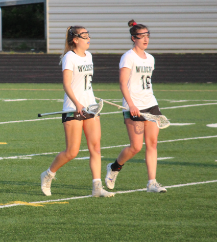 Senior midfielders Ellie Hilton (left) and Olivia McCloskey (right), pictured walking off the field during a game. The two players were both captains, and they both played a key role to lead the girls lax team to win regionals.
