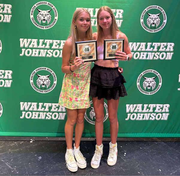 Sisters Mackenzie and Megan Raue accept their MVP award at the spring athletic awards night. They have both worked hard for this achievement and are very excited about it.