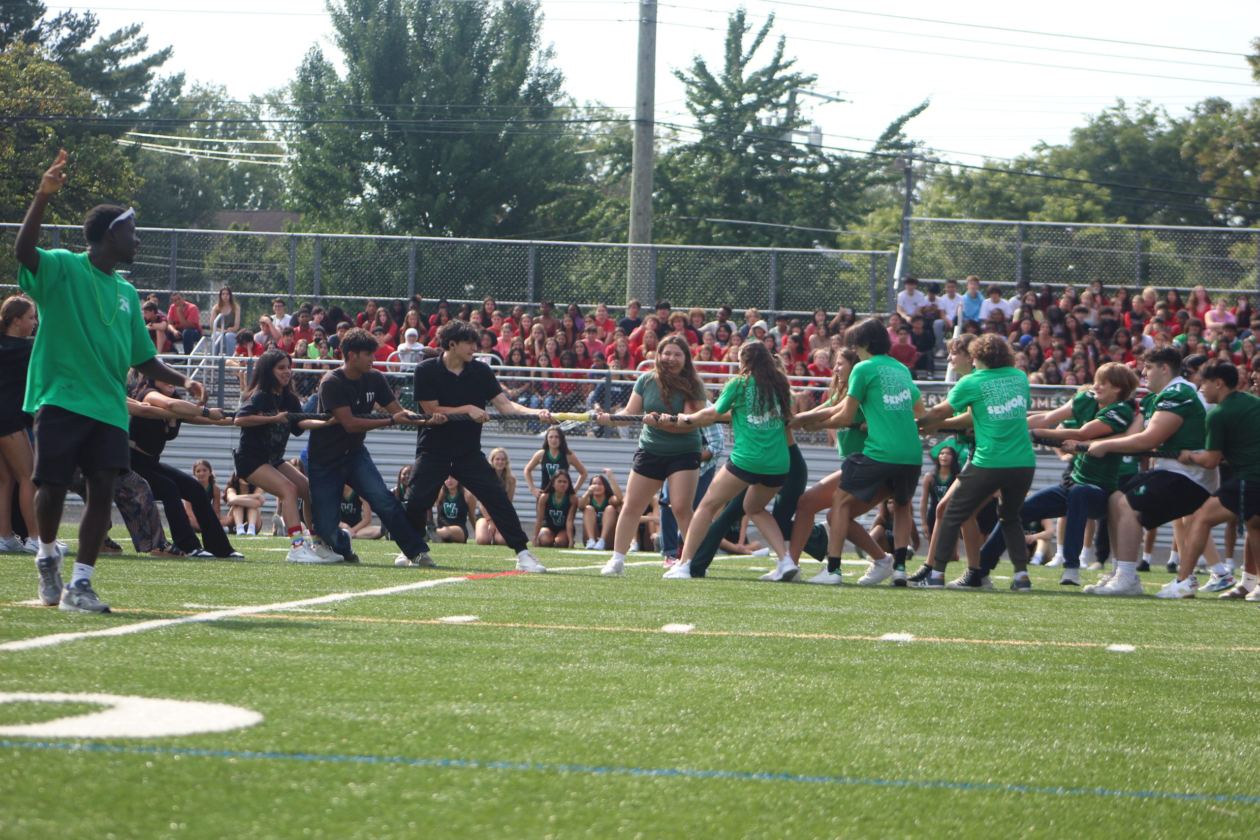 Freshmen watch in the distance as the juniors and seniors face off on the 50-yard line in the annual tug-of-war. The seniors overpowered the juniors on-route to winning the whole tournament.