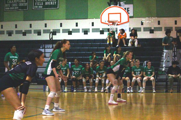 Sophomore Celiana Caraballo, junior Stella Lichter and junior Claire Kuemmerle get ready to return a serve against Quince Orchard on Sept. 13 . The team rebounded from a loss two days prior, winning 3-1.