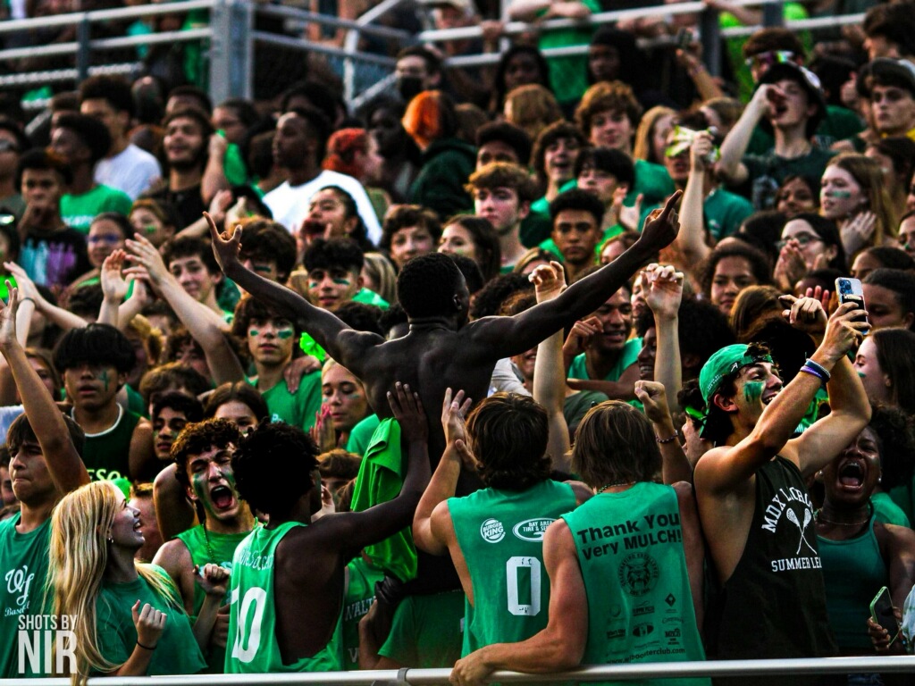 Students at a home football game cheering on their team. Because of football games getting moved to thursdays, the student section might become less packed than a normal friday.