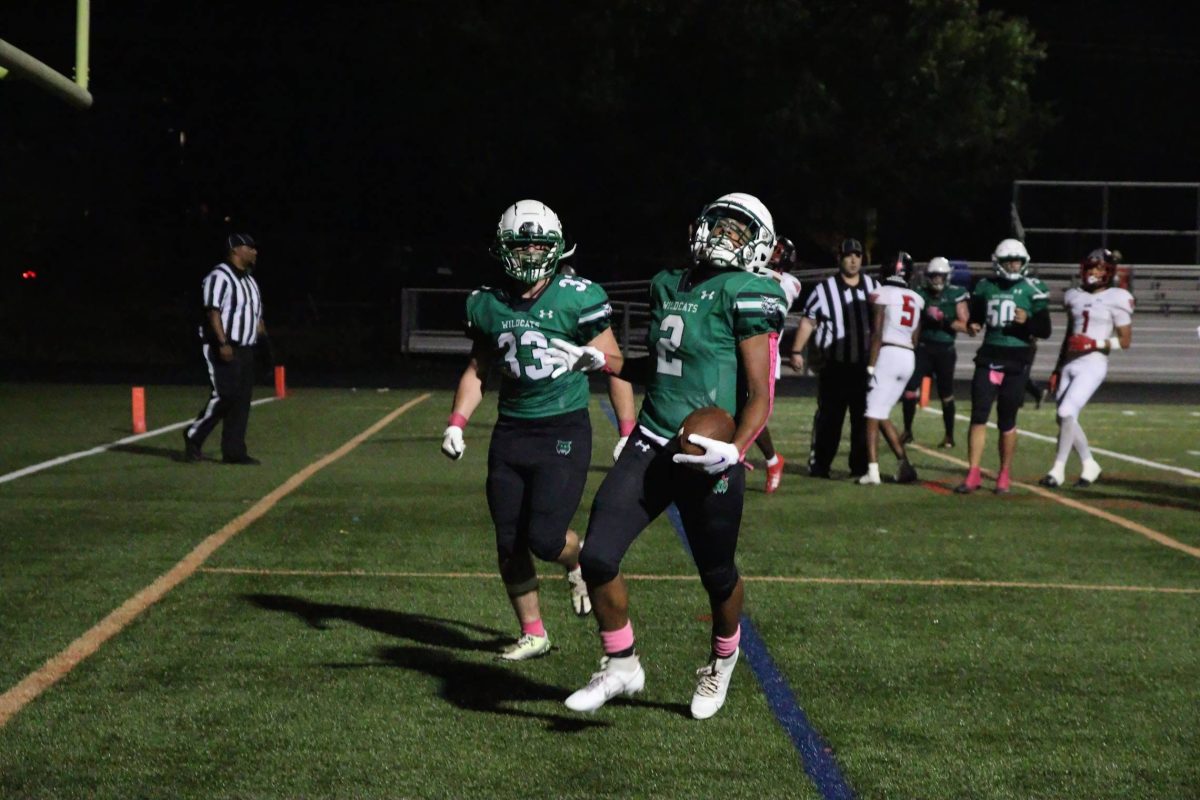 Junior John Jernell and sophomore running back Dylan Byrd celebrate scoring a touchdown against the Blair Blazers. Byrd has been a key player for the Wildcats offense this season.