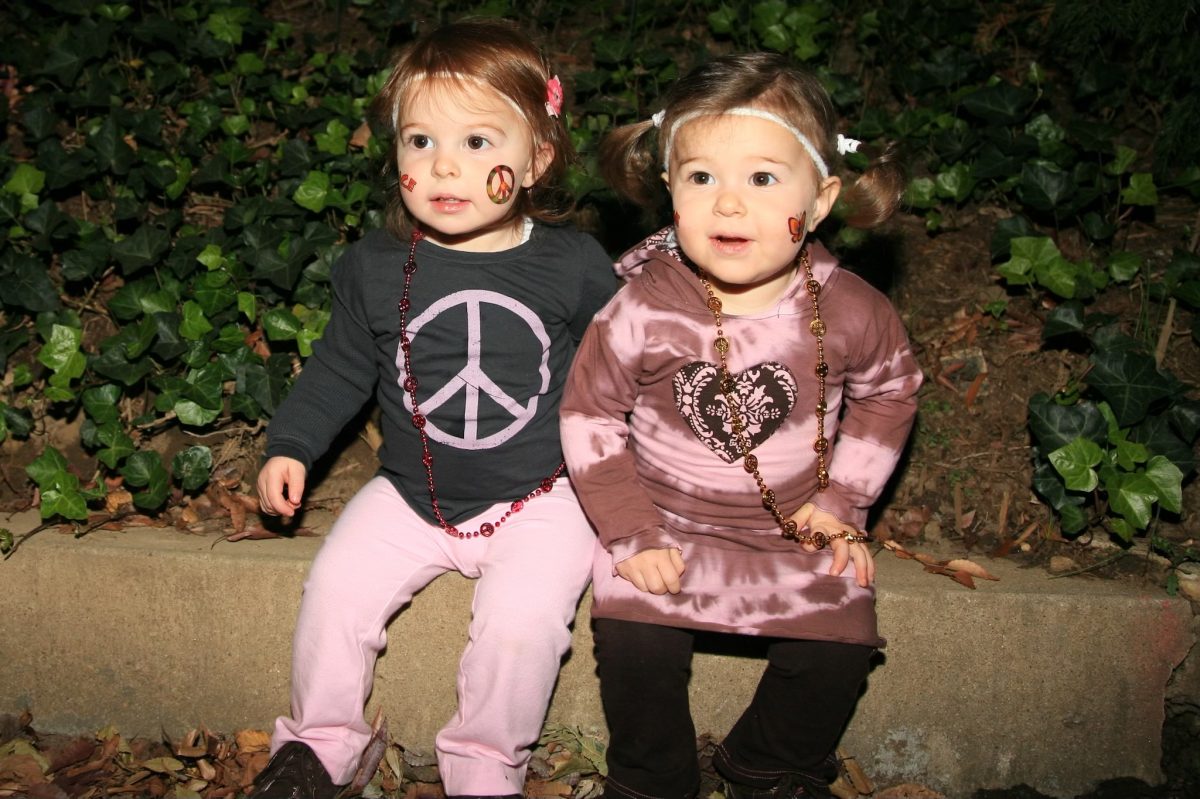 Sasha+and+Gabby+Rappaport+sit+outside+their+house+on+a+cold+and+spooky+Halloween+night.+Dressed+in+matching+hippie+costumes+and+face+paint%2C+they+easily+swooped+up+the+cutest+costume+award.