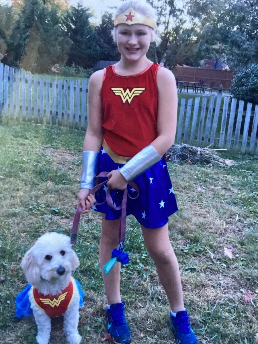 Senior Lyn Mckaig poses with her dog before going trick-or-treating together. It was such a fun experience to bring my dog with me on Halloween night, Mckaig said.