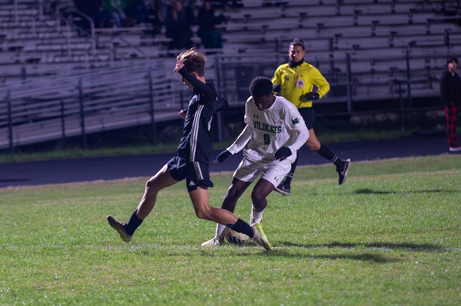 WJ senior striker Loic Nsoga-Mahob skillfully moves past Northwest junior defender Noah Henseler to score the game-winner in overtime. Nsoga-Mahob has scored the game-winner in three of the teams past four games.