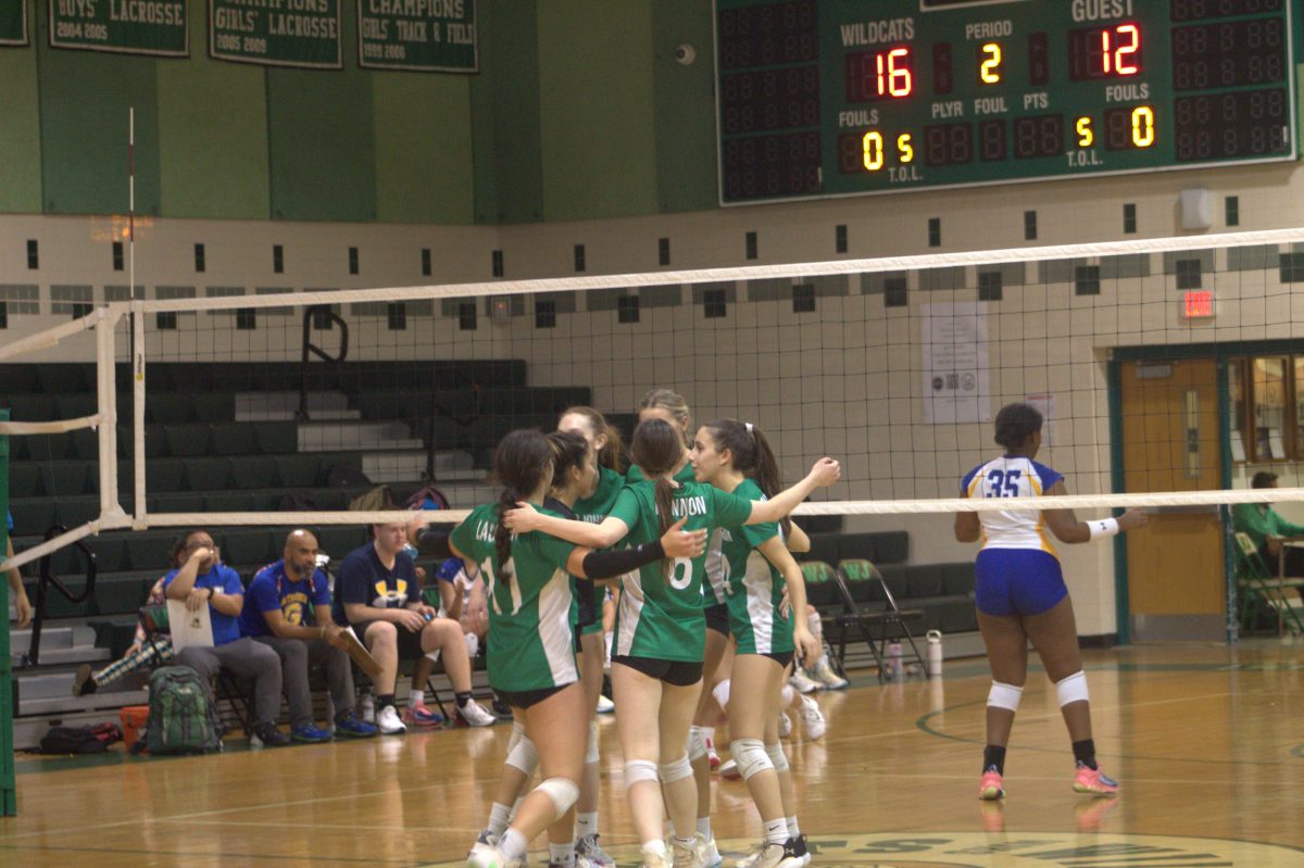 The Wildcats huddle together after a point at home against Gaithersburg HS. The Cats won the game 3-0, extending their current 3-game win streak.