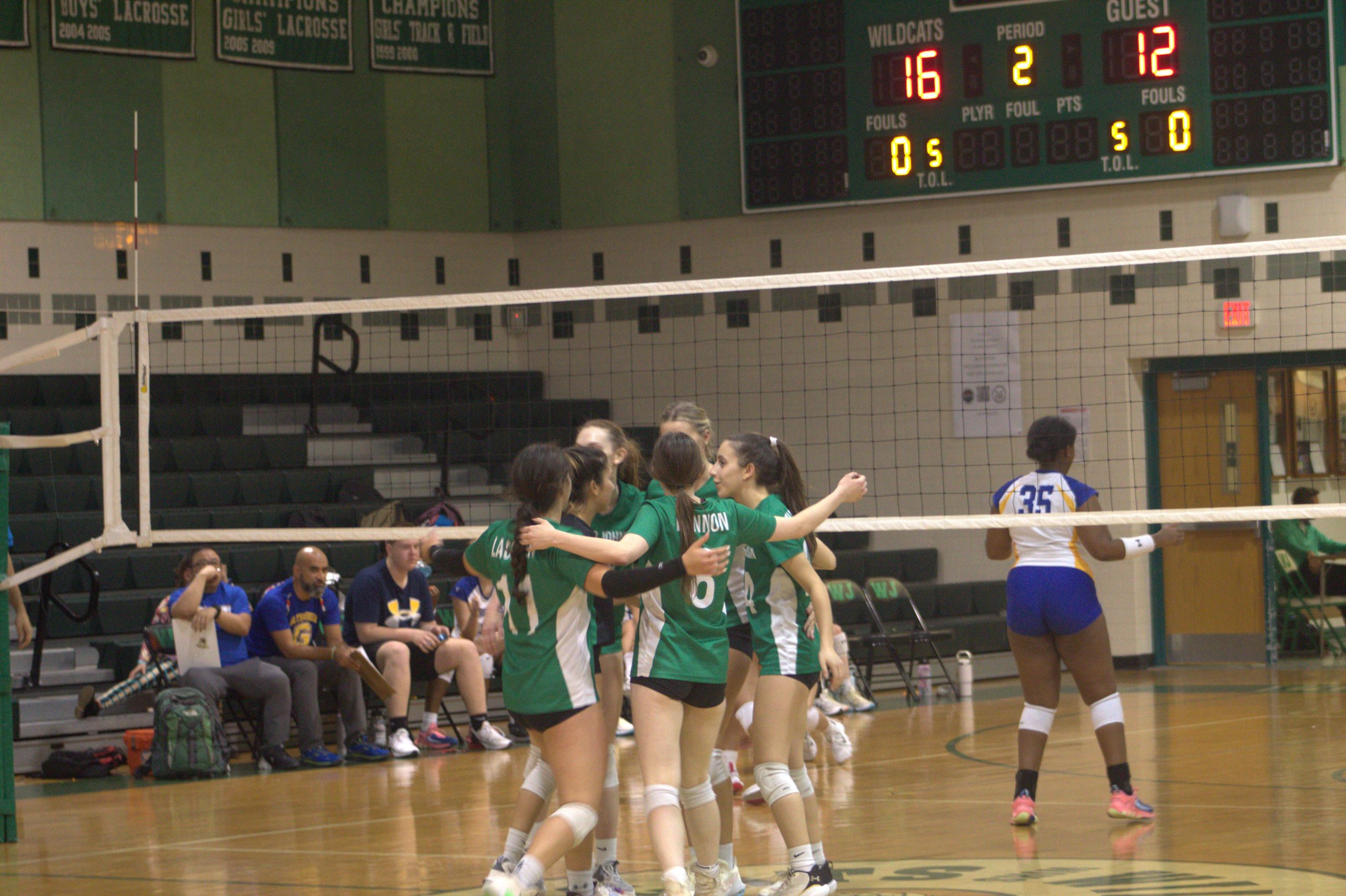 The Wildcats huddle together after a point at home against Gaithersburg HS. The Cats won the game 3-0, extending their current 3-game win streak.
