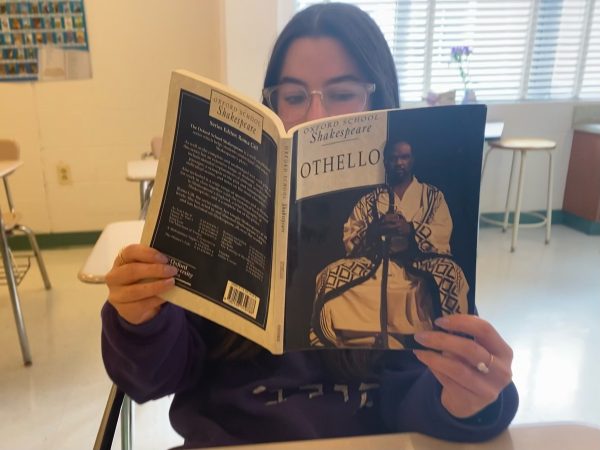 Senior Paulina Horowitz reads Othello in Melanie MacFaddens sixth period AP Literature class. There are parallels to the tragedys theme and our society.