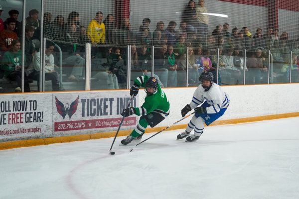 Freshman forward Matthew Corwin skates with the puck as a Sherwood skater attempts a poke check. With their 11-1 win over Sherwood, the Icecats have started their season 2-0.