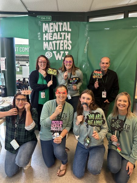 Administration and staff pose with handmade wellness signs. Were so excited about everyone who participated or stopped by. We hope these activities brought a little bit of positivity to your day, Youth Development Specialist Payton Belisle said.