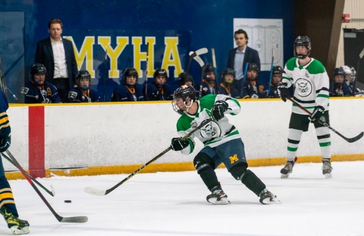 Senior Jon Corwin passes the puck up the ice to teammates hoping to keep the lead. In the second period, the Icecats scored one goal leaving them up against the Barons 4-3.