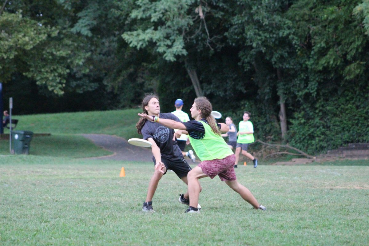 Senior Matias Hazbon throws the disc around the mark set by Whitman junior Dante Barutta at a pre-season practice.