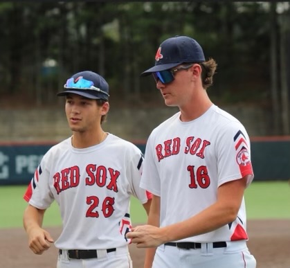 Seniors Jake Goldberg and Aidan Watts walk to the dugout after a successful inning at a college showcase for their travel team. Playing on the Red Sox with Aidan has been an amazing experience and has definitely prepared us for the college level, Goldberg said.