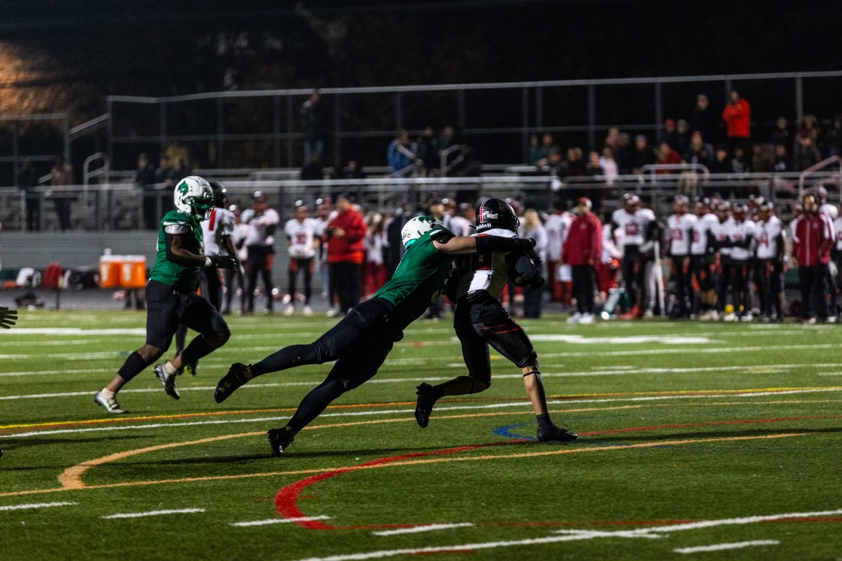 Senior linebacker Dylan Minnick tackles junior Blair wide receiver Jay Mendoza in the second round of the MPSSAA playoffs. With the Wildcats win over the Blazers, the Cats advanced to the schools first-ever state quarterfinal.