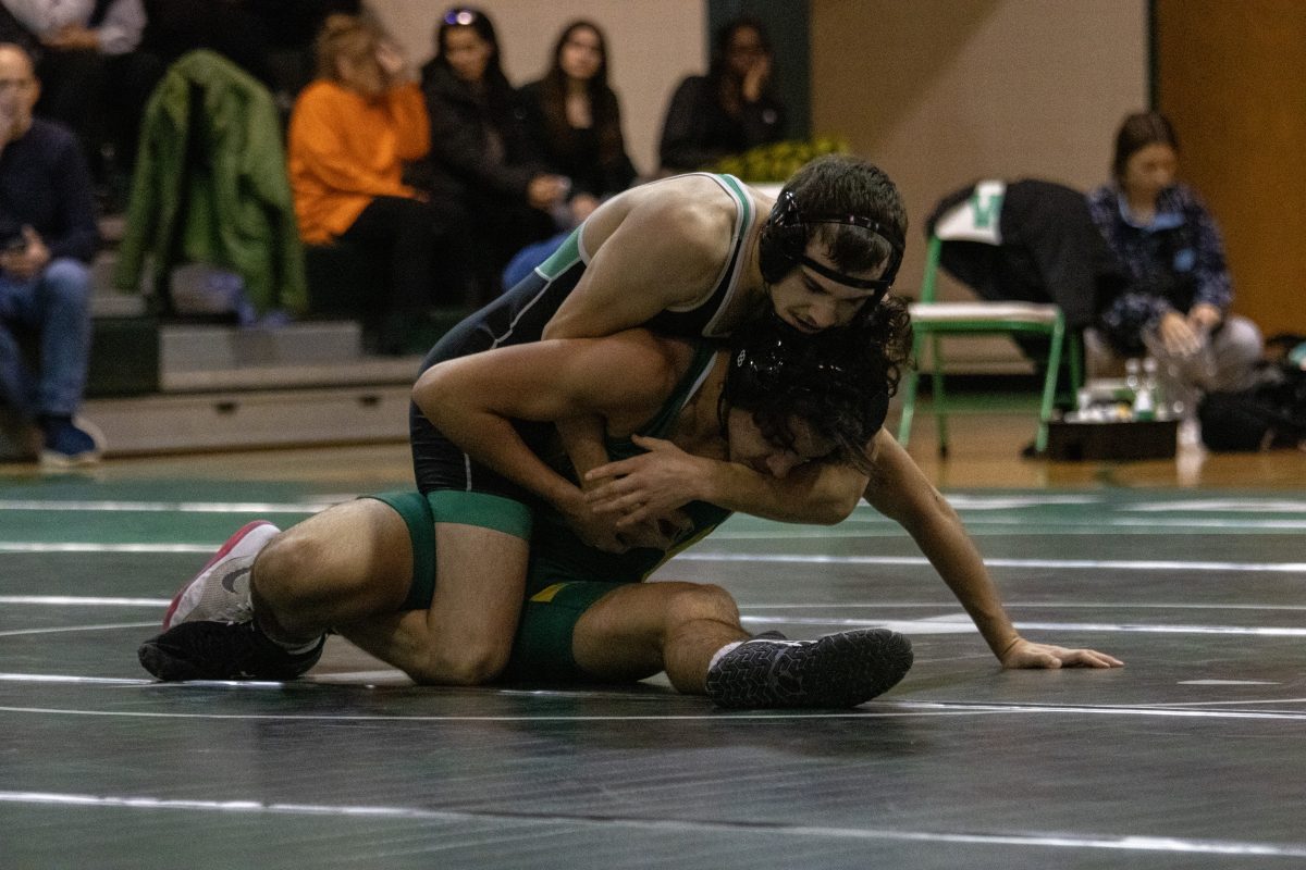 Senior Zach Morales wrestles against an opponent in the first match of the season against Seneca Valley. The Wildcats beat Seneca Valley 49-27 and have gone 3-2 to start the season.