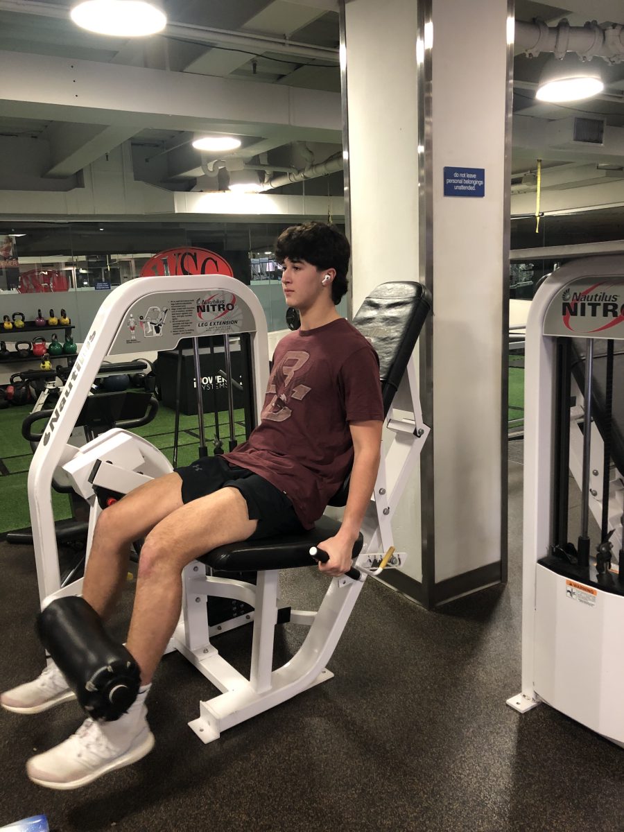 Sophomore Ethan Pletter works out at Washington Sports Club. This was one of the last times he used this machine as the gym closed on January 31.