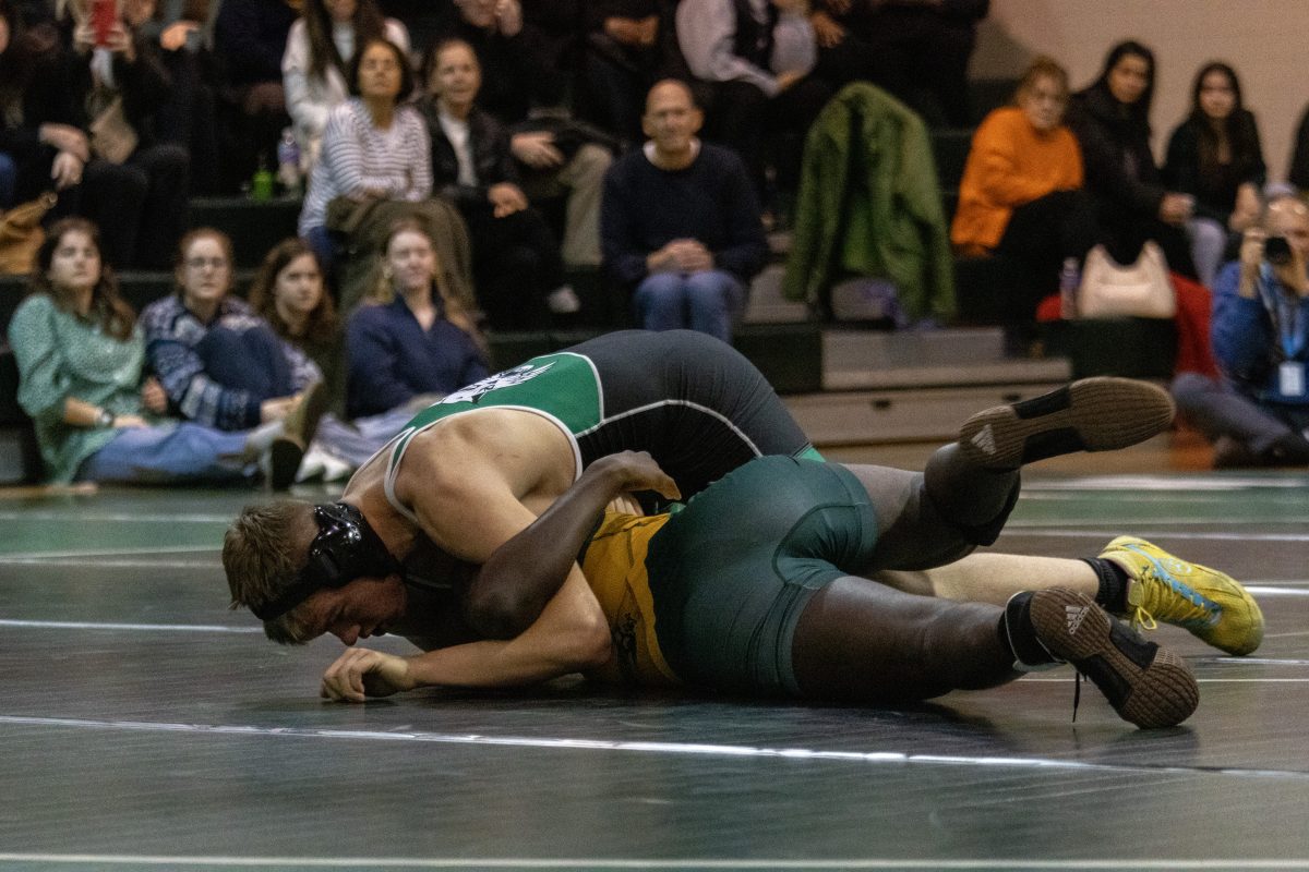 Junior Hudson Barrett works on pinning down an opponent to score points for WJ in a match vs Seneca Valley High School earlier in the season. Barrett and the Cats will look to perform strongly in the upcoming MCPS championships to advance further.