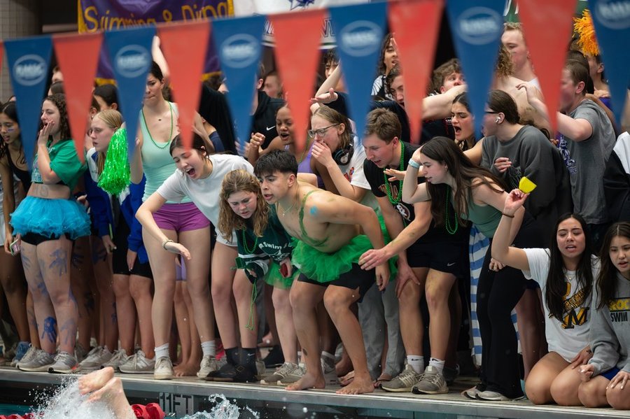 WJ swim cheers on their swimmers as they compete in Metros on Feb. 10.  The Aquacats are known for their spirit as they don the famous WJ green.  I was definitely really nervous but the energy was so supportive from my team, junior Isla Bartholomew said.