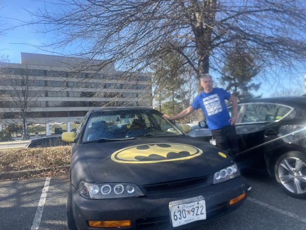 Math teacher Steven Kerr shows off his Batmobile. He painted it nine years ago for fun after a request from his kids.