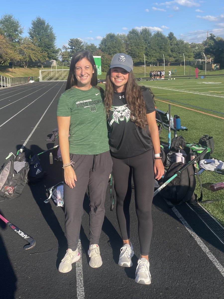 Math teacher Laura Brager and PE teacher Lauren Fakler pose together on the sidelines of a field hockey game in the fall. The two have formed a close bond over the past three years both in the school and out on the turf.
