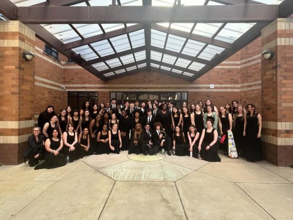 Advanced Choir poses outside Clarksburg High School in their concert  outfits.
