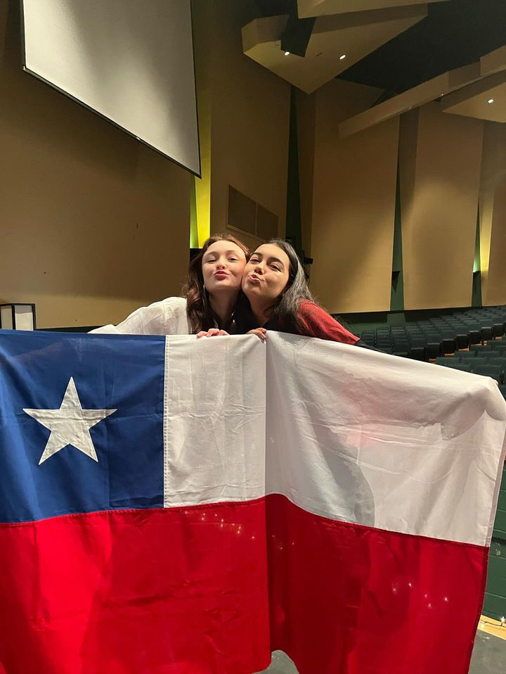 Juniors Elisa Karich and Agustina Llanos stand in front of the Chilean flag while preparing for the Latin America Assembly which showcased the diverse and intriguing aspects of Latin American culture. “I ended up becoming friends with people that spoke my language, Spanish, but eventually after getting comfortable with them, I started getting more comfortable with people that spoke English,”  Karich said. 