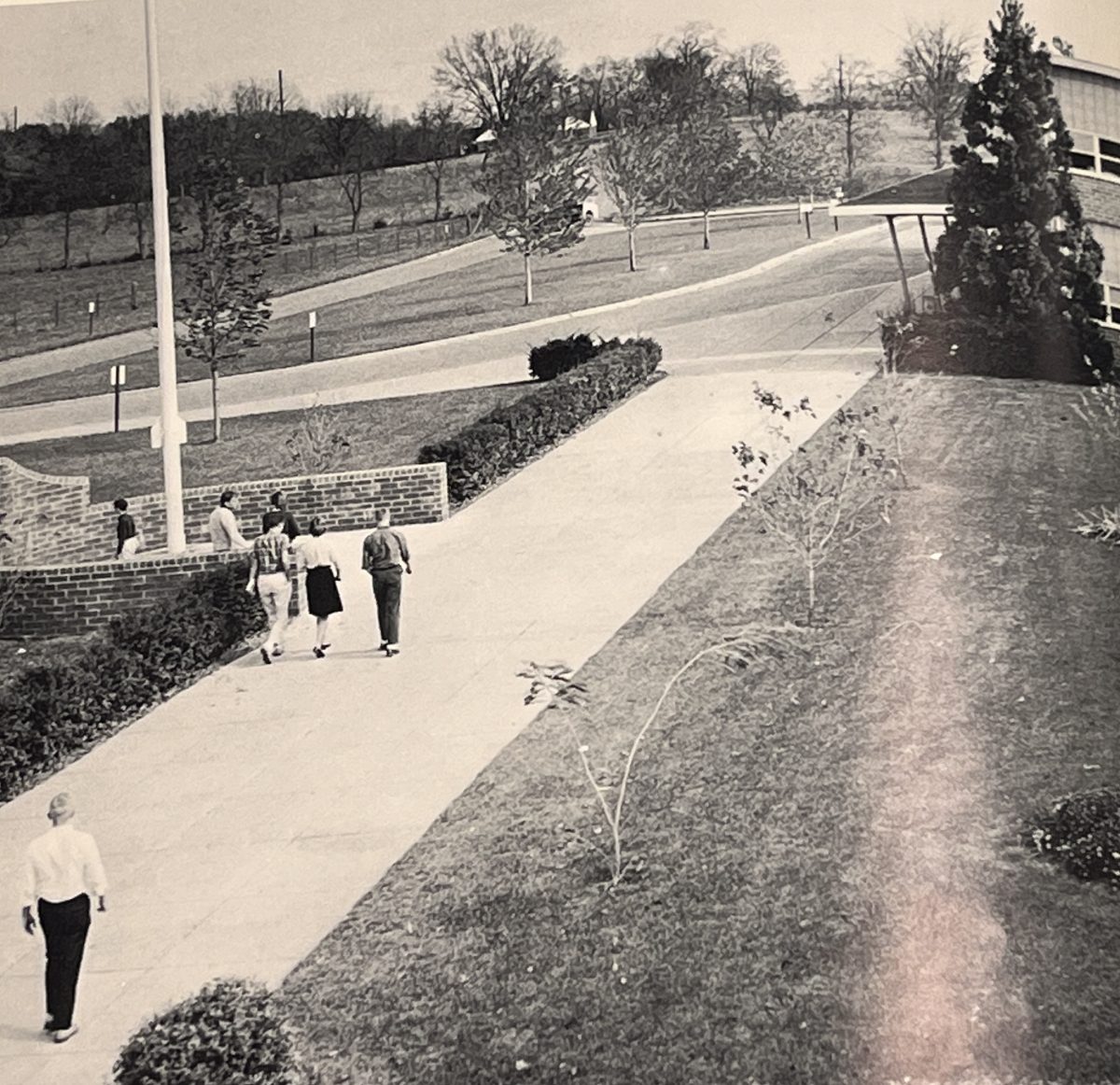 The school campus looked dramatically different from what is is today. Grassy fields and open spaces where students used to hang out have been turned into parking lots and athletic spaces.
