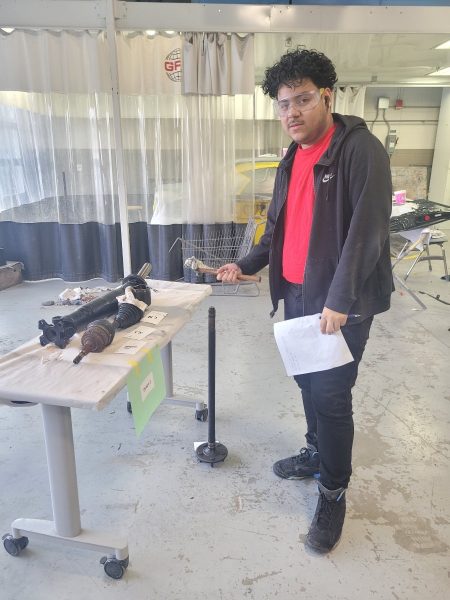 Junior Angel Melgar examines axles and other car parts while participating in the Auto Collision and Repair program at Edison. Its helping me reach my goals of being a mechanic and working in shops, Melgar said.