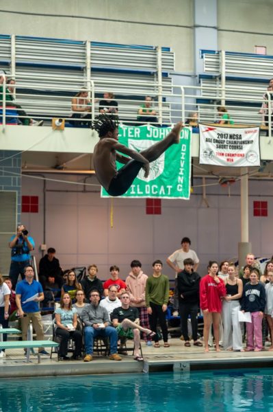 Junior Kai Lawson performs a 103B, which is one-and-a-half front flips in a pike position at the first meet against B-CC.  His skill has been a weapon for the Aquacats this season as he has consistently placed high in his meets.