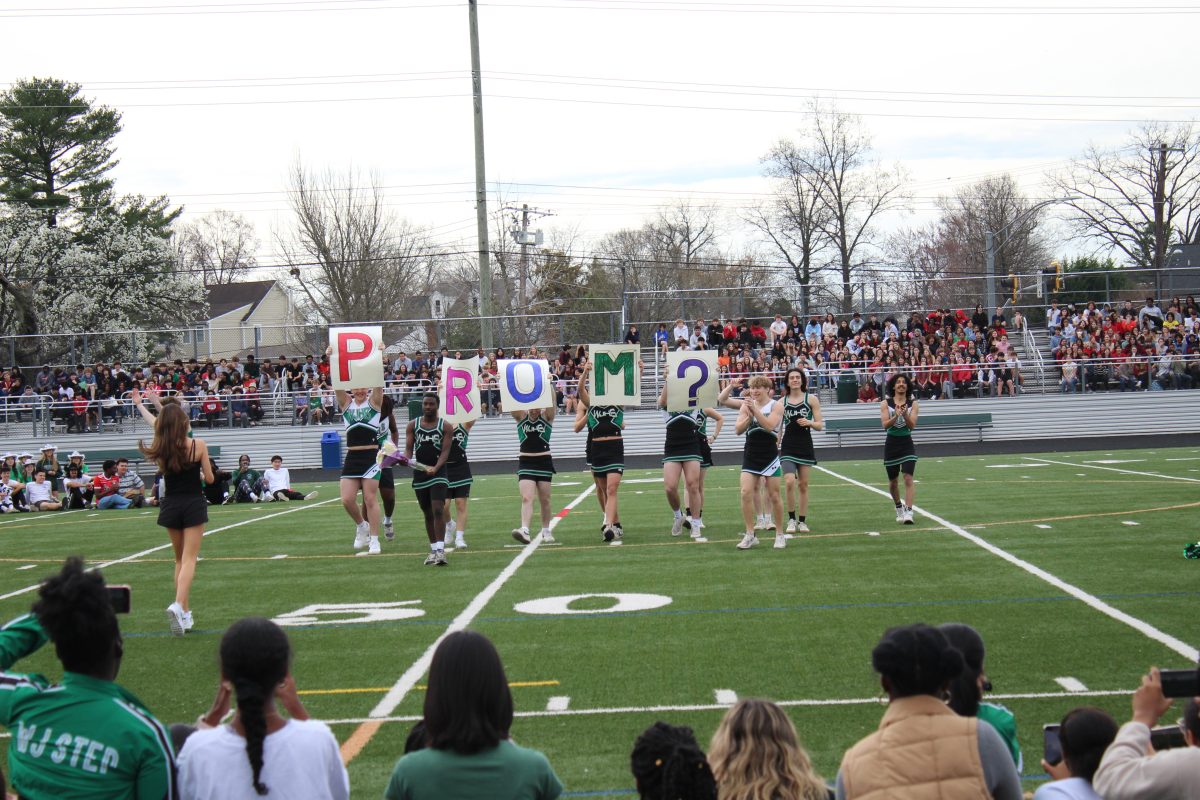 Senior Sidney Scale promposes during the spring pep rally to his girlfriend after the male pops performance. I was really surprised and kind of like nervous but it ended up being really good so Im grateful, senior Maria Goergen Alvarez said.
