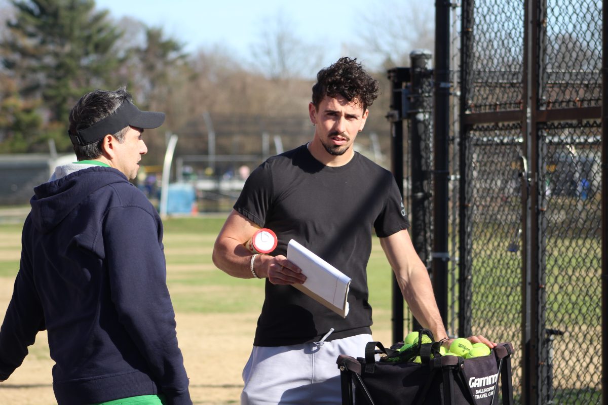 New boys tennis coach Franck Soulerot talks with girls coach Mitch Duque. Soulerot played college tennis at Seward County College and Middle Georgia State. (Courtesy WJ Boys Tennis)