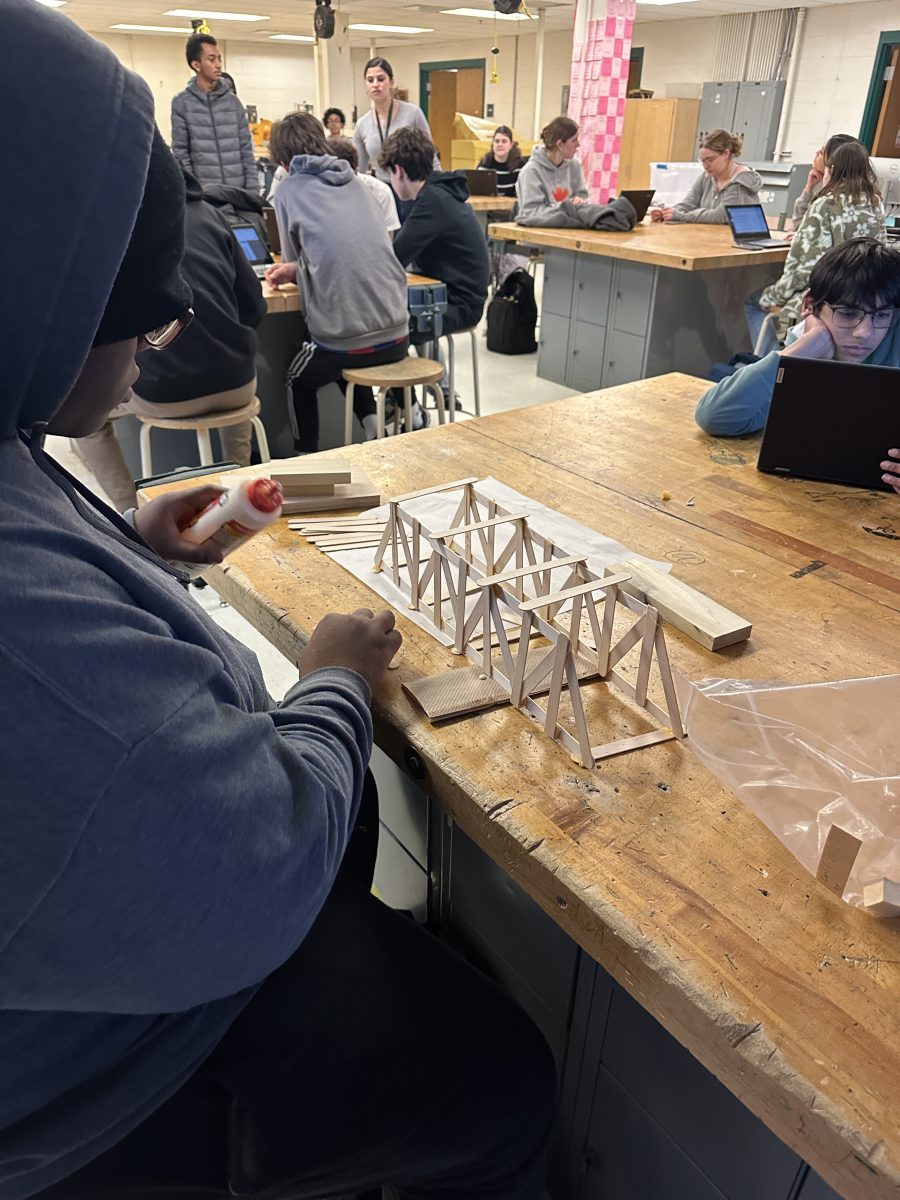 Foundations of Technology work on building bridges and testing them to see if they can endure a certain amount of weight. Kids work with popsicle sticks and glue to try and build a sturdy foundation.