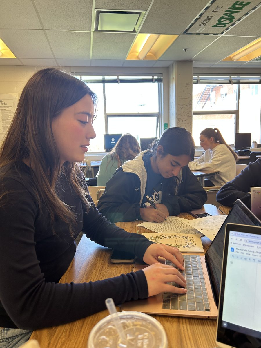 Senior Sara Elster and junior Maya Panicker diligently work on their schoolwork, which they will be doing more often with the implementation of year-round school.  