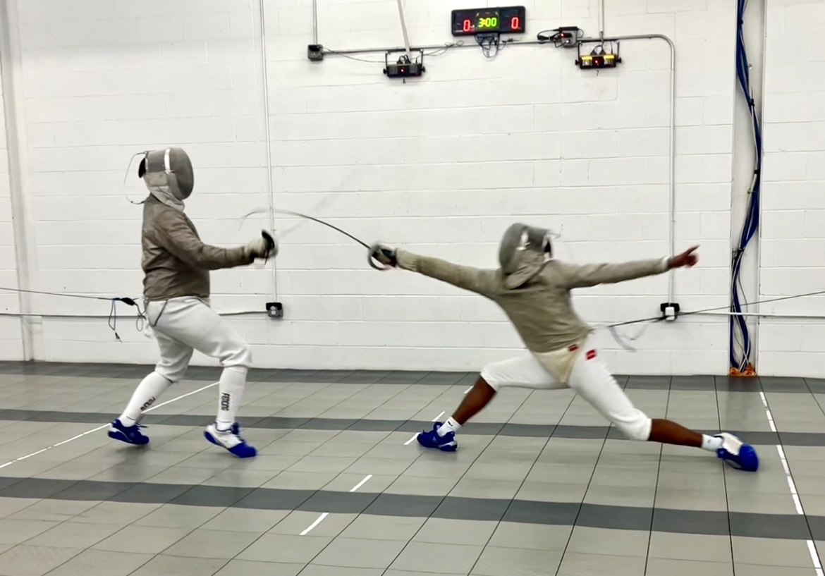 Senior Karthik Shankar (right) open fences against his teammate during practice. During this round, he lunged to attack as the opponent tried to defend.