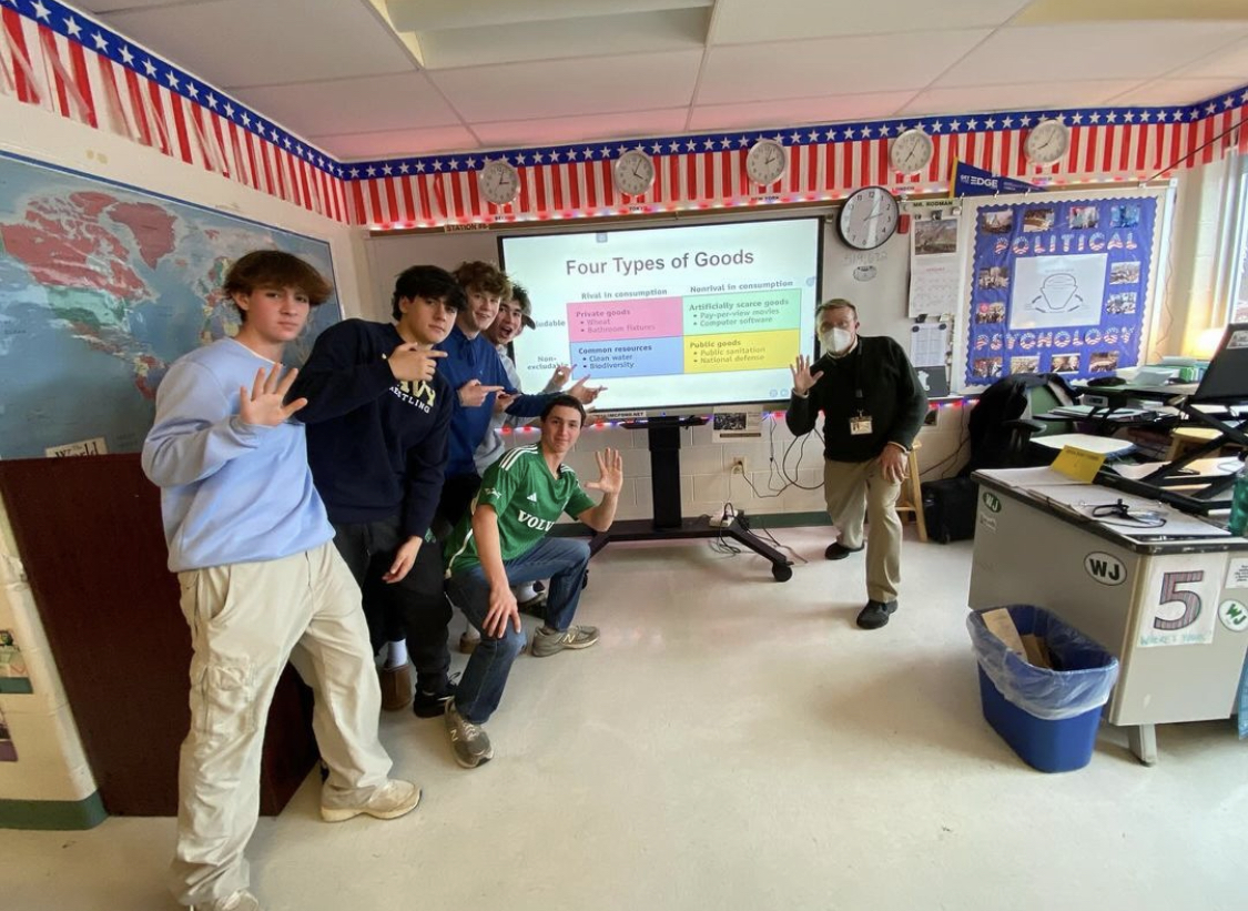 After learning about the four types of goods, Timothy Rodmans seventh-period microeconomics students do the signature living the 5 pose. This pose represents how their knowledge will help them be successful on their AP exam in May.