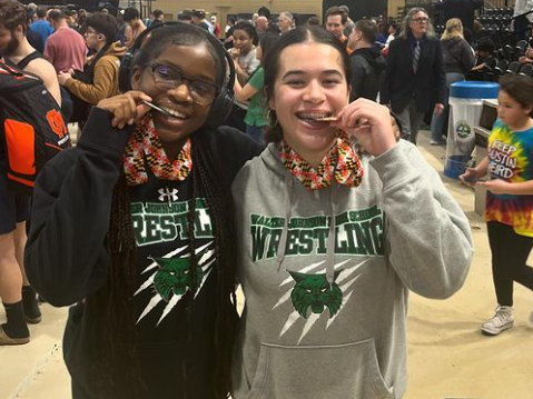 Sonia Pegoue (left) and Maddox Zuniga (right) celebrate with their medals after the Maryland state championships. Pegoue placed second and Zuniga placed sixth in their respective weight classes.