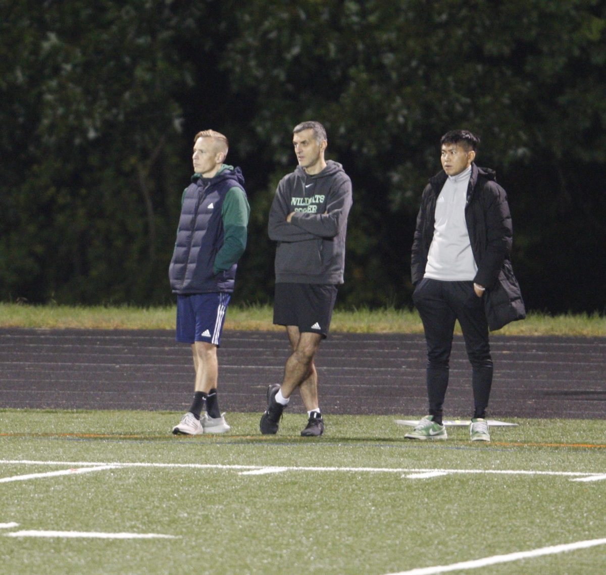 Alec Latifov (middle) watches WJ girls varsity soccer battle Whitman in their 2022 regular season conference match.  He stood alongside former head coach Joshua Kinnetz (left) and current assistant coach Fumie Takahashi (right) in his 27th season with WJ girls soccer.