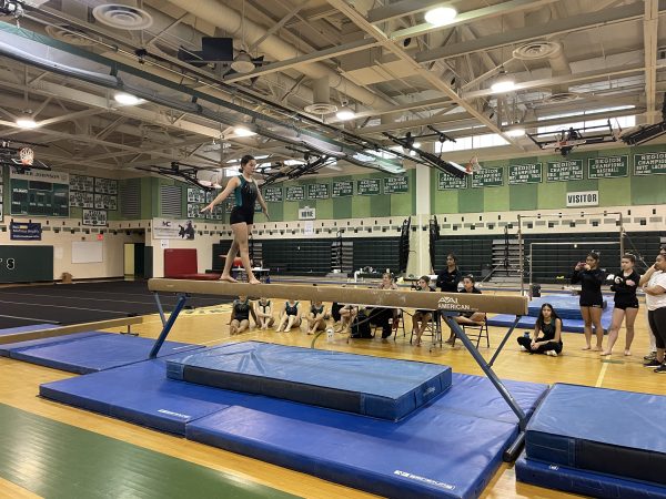 Senior Rachel Finn starts her balance beam event, helping the Gymcats score more points to close the gap between the Vikings. Im really proud of all of us. Whitman are tough competition and the fact that we were that close makes me so excited for our future performances! Finn said.