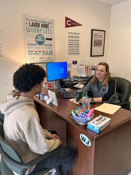 Senior Lucas Jaho discusses college acceptances with counselor Ashley Weddle. So far, Jaho has been admitted to the University of Michigan, Penn State University, the University of Pittsburgh and Ohio State University. The University of Pittsburgh, Penn State and Ohio State are among the list of colleges who have pushed back their decision deadlines due to FAFSA delays.