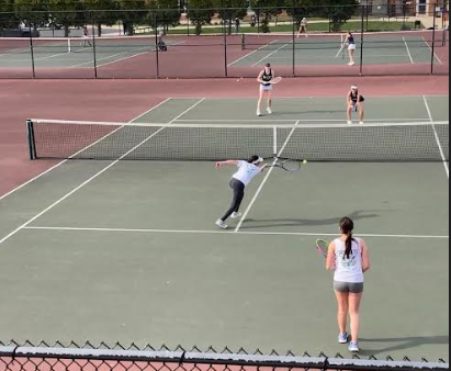 Junior Miram Elag hits a volley against B-CC on Monday. Elag, along with freshman Zoe Rojas, were the number one doubles pair against B-CC. They won their match in straight sets (6-3, 6-1), helping the Wildcats to sweep the Barons to remain undefeated. (Courtesy Mia Milicevic)
