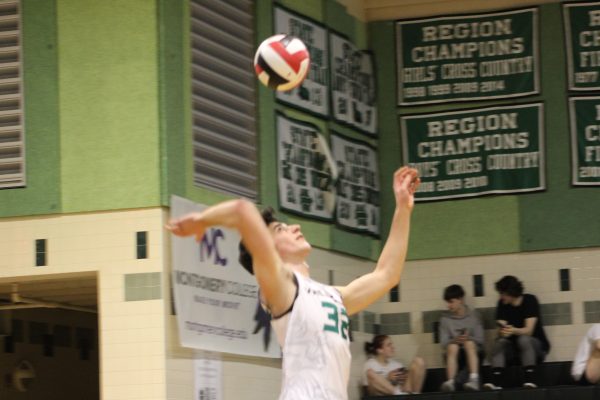 Senior Peter Hristov serves on for set point against B-CC. The Wildcats ended up winning the set 27-25. We just kept our energy calm and collected. We didn’t get too rowdy. We wanted to stay as calm as possible and make sure their attacks weren’t bringing us down, senior captain Victor Goerlitz said.