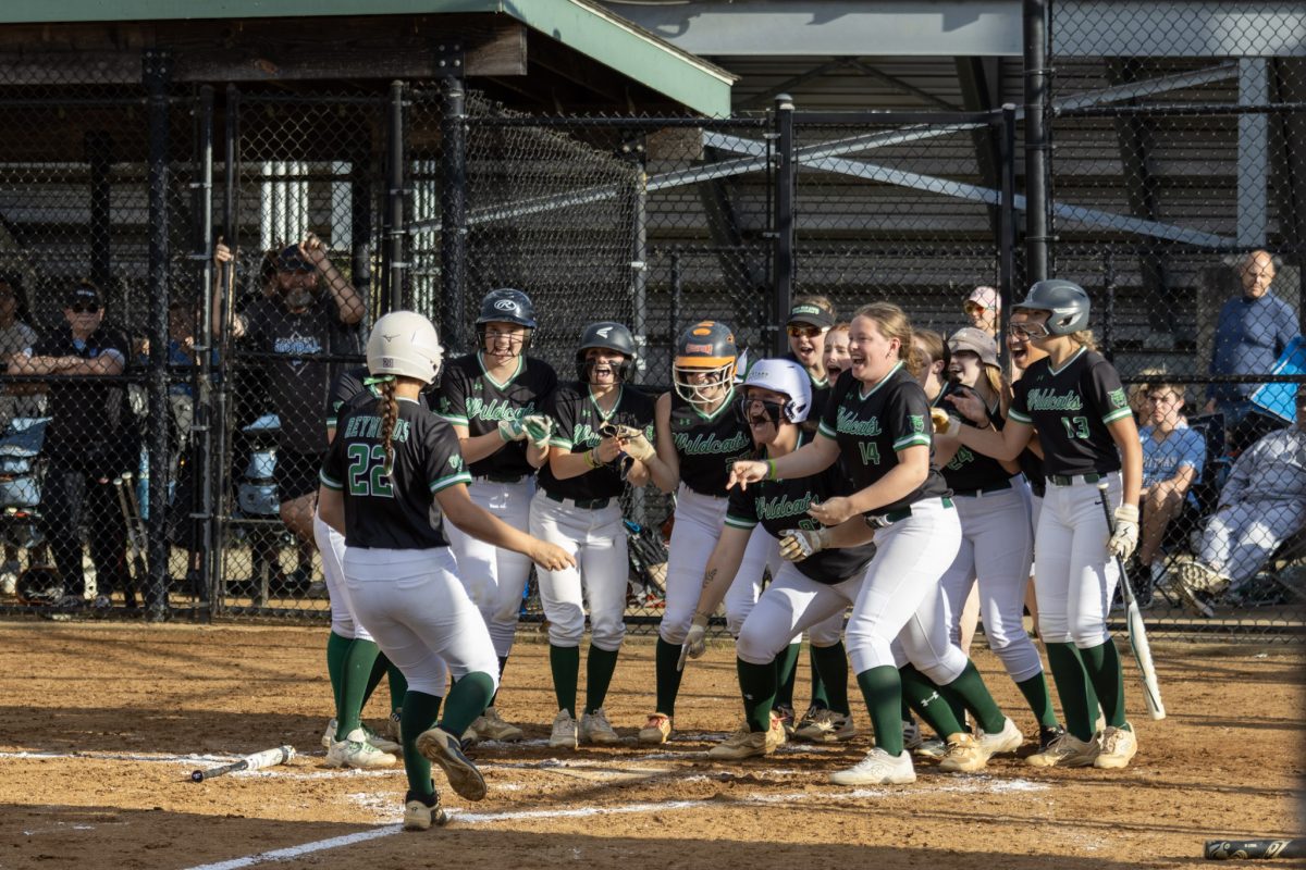 Sophomore third baseman Ella Reynolds approaches home plate as the team celebrates her grand slam. Reynolds gave the team a 4-0 lead in their regional final.