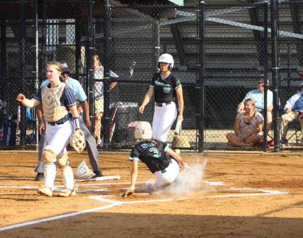Sophomore shortstop Addie Strbak slides into home plate to open the scoring for the Wildcats. Strbak and the teams offensive hitting led them to a 9-7 win over Urbana HS in the 4A state quarterfinal Monday. 